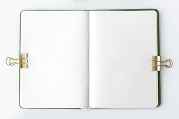 Blank notebook page with bulldog clips design element