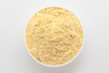 Organic Corn Flour (Zea mays) or Makka Flour, in a white ceramic bowl. Isolated on a gray background. Top View