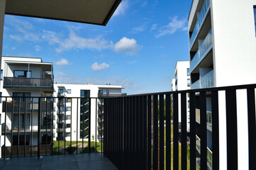 Modern Polish residential buildings stand tall, showcasing sleek architecture and contemporary...