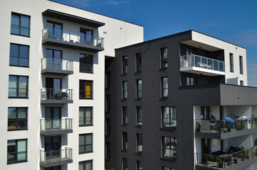 Modern Polish residential buildings stand tall, showcasing sleek architecture and contemporary...