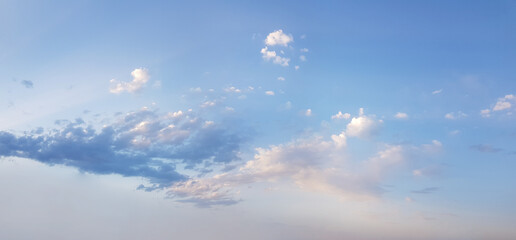 Soft blue sky has the light of the sun and small clouds, weather background