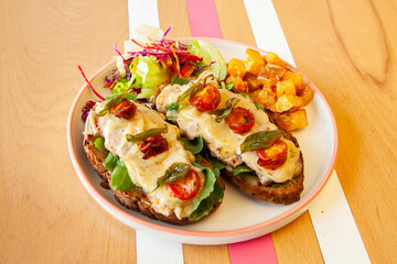 open-faced sandwich on multigrain bread. Topped with grilled chicken cherry tomatoes and honey mustard..