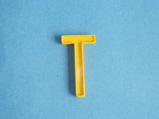 Macro photo or closeup photo of the alphabet from children's toys on a blue background. Use on...