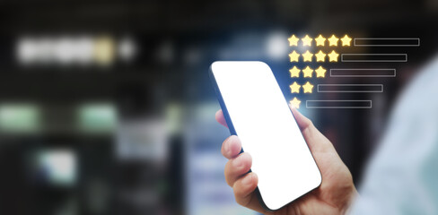 Hand holding smartphone device and touching screen and star