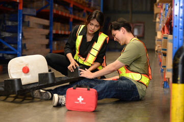 First aid support accident at work of worker at factory. Male worker has an accident on the floor...