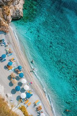 A sunny day at the beach with many colorful umbrellas, ideal for a fun family vacation or a relaxing getaway