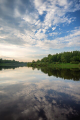A river reflecting the sky with clouds