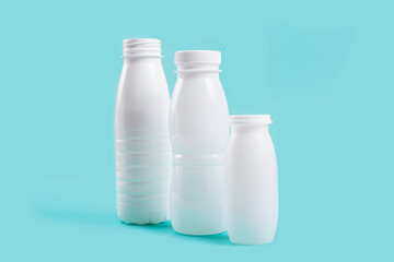 White plastic bottles arranged against a blue backdrop, symbolizing eco-conscious choices and environmental stewardship in packaging design.
