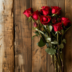 A fresh bunch of red roses placed on aged wooden planks, symbolizing love and passion