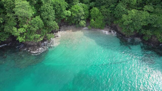 Scenic Aerial Flyover Beautiful Clear Blue Ocean Water At Secluded Penca Beach, Costa Rica 4K Drone