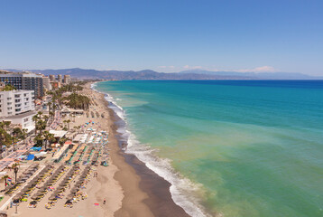 view of a crowded beach in Spain, in Summer