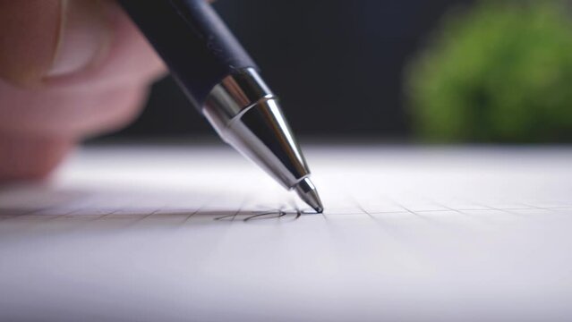 Apply a signature to a document. Ballpoint pen in close up