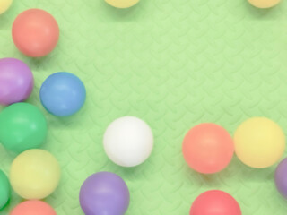 Children's greeting card with colored balls on green textured background with copy space