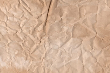 Old parchment vintage paper with a glowing and Brown crumpled wet craft texture grunge vignette copy space empty background.