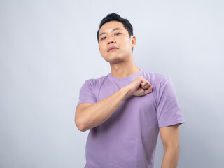 Young Asian man in a light purple shirt with a confident expression, crossing his arms in a strong...