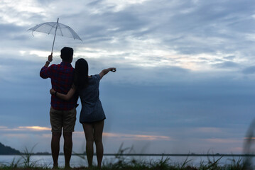 Couple in love having romantic tender moments at sunset on the beach - Young lovers having tender moments in summer vacation - Love concept