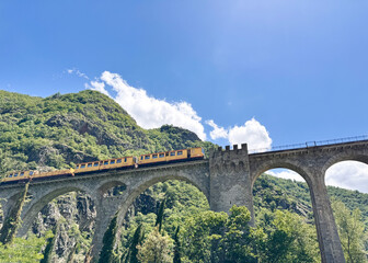 The yellow train (Le Petit Train Jaune) en route in Occitanie, Pyrénées Orientales.