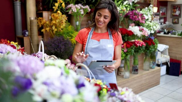Happy, young woman owning a flower boutique