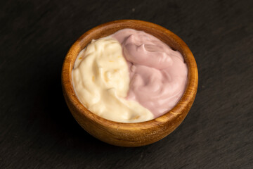vanilla and raspberry flavored yogurt in a wooden bowl