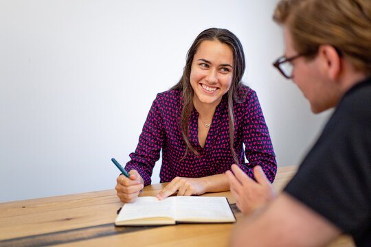 Aboriginal woman talking to a man with glasses in an office - Powered by Adobe