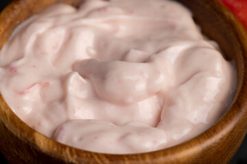 yogurt made from milk with added flavor and pieces of ripe strawberries