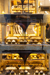 Showcase of a store with flowing liquid chocolate in Italy