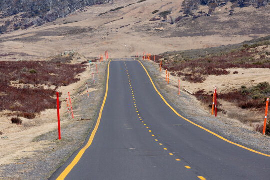 Snowy Mountains Highway, an alpine road with yellow road markings and orange snow guides