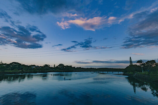 Children playing in the shallow water of Simpsons Creek, late afternoon at Brunswick Heads
