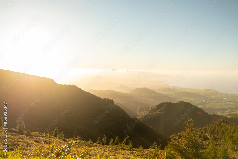 Wall mural Epic sunset over the lush green of the volcanic island. North side of São Miguel Island in the Azores