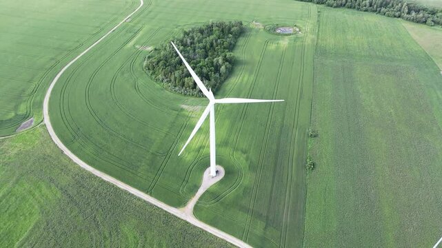Aerial view of a vast, picturesque farmland with a windmill in Mapleton, Ontario, Canada