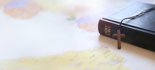 Holy cross of Jesus Christ, Bible book, world map background and mission, gospel and evangelism concept
