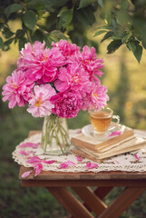 Photo of a bouquet of pink peonies in the garden.
