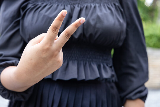 Impolite gesture concept image, Hand of African woman showing British version of  insulting V sign