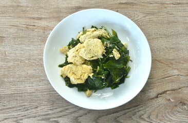 fried Melinjo tropical vegetable with egg on plate