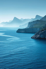 Fototapeta premium Blue horizon featuring a tranquil ocean and minimalist mountain range in the distance,
