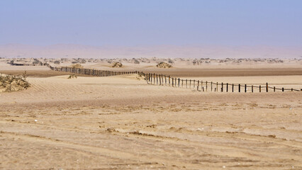 Old border fence in the desert near Walvis Bay in Namibia
