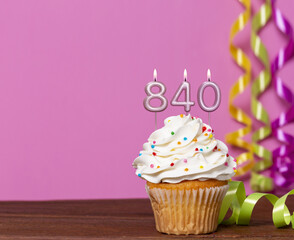 Birthday Cupcake With Candles Lit Forming The Number 840