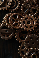 Close-Up of Vintage Brass Gears and Cogs in Dark Background