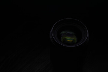 Close-Up of Camera Lens in Low Light: Black Background and Lens Reflections