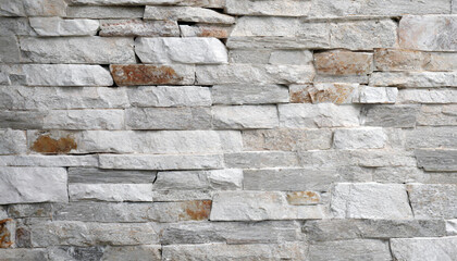 Stone wall texture background - grey stone siding with different sized stones