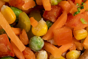 a mixture of quick-frozen corn, peas, peppers, and carrots