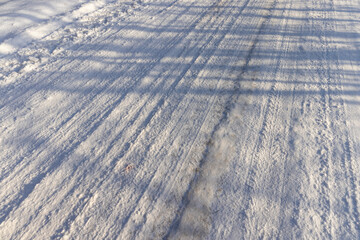 a road covered with snow that is dangerous for motor vehicles
