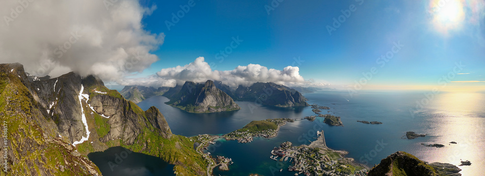 Wall mural Gorgeous view of Lofoten, Norway, mountains & fjords. Sun shines bright, casting golden glow on water, showcasing stunning natural beauty. Reinebringen, Lofoten, Norway - Wall murals