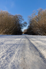 a road covered with snow that is dangerous for motor vehicles