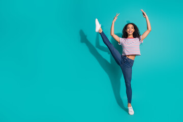 Full body photo of attractive young woman flexible dancing ballet dressed stylish striped clothes isolated on aquamarine color background