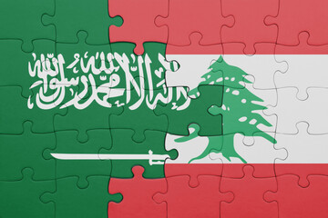 puzzle with the colourful national flag of lebanon and flag of saudi arabia.