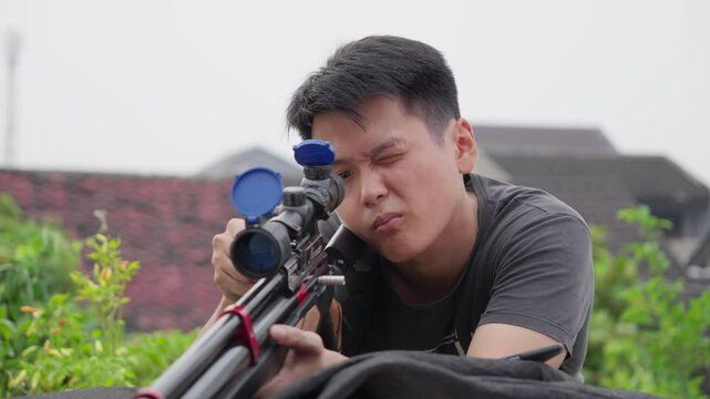 Sharpshooting asian with scoped PCP air rifle
