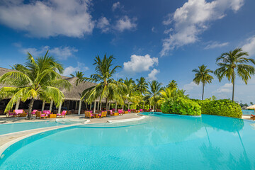 Stunning landscape, swimming pool blue sky clouds. Tropical resort hotel in Maldives. Fantastic relax and peaceful vibes, chairs, loungers under umbrella and palm tree leaves. Luxury travel vacation