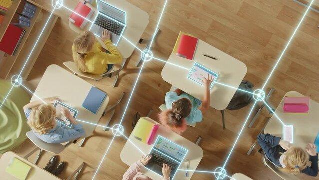 Top down View: Children in a School Use Tablets and Laptops to Study Digital Literacy, AI Data Lines Connect into Learning. Diverse Kids Connected Through Digital Knowledge Network, Modern Technology