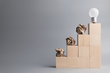 Crush paper balls and light bulb in concept of development and original idea, learn from mistakes,...